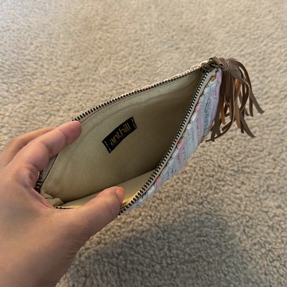 Handcrafted clutch with woven fabric, straw bottom, leather tassel